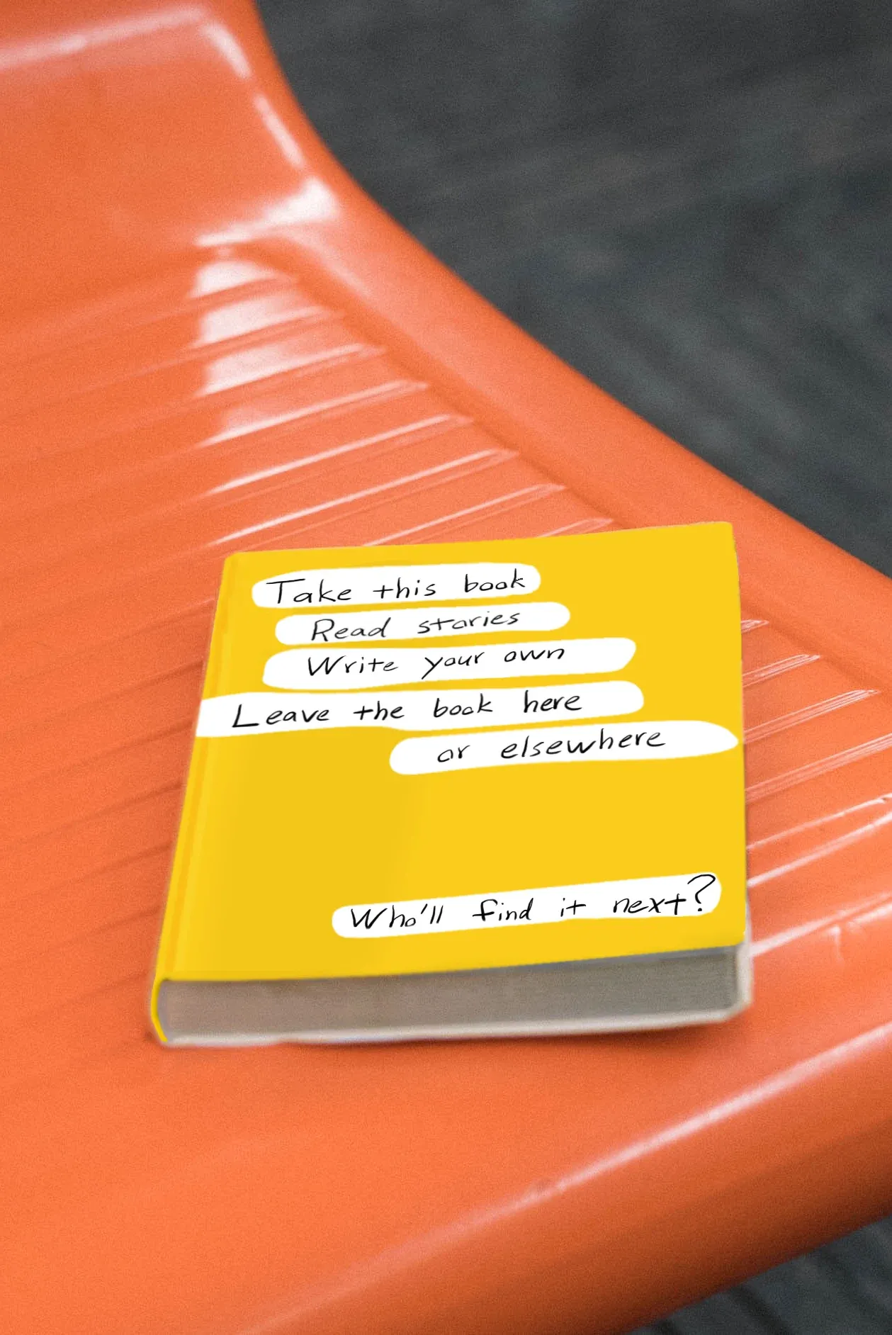 A yellow book lying on a bench.